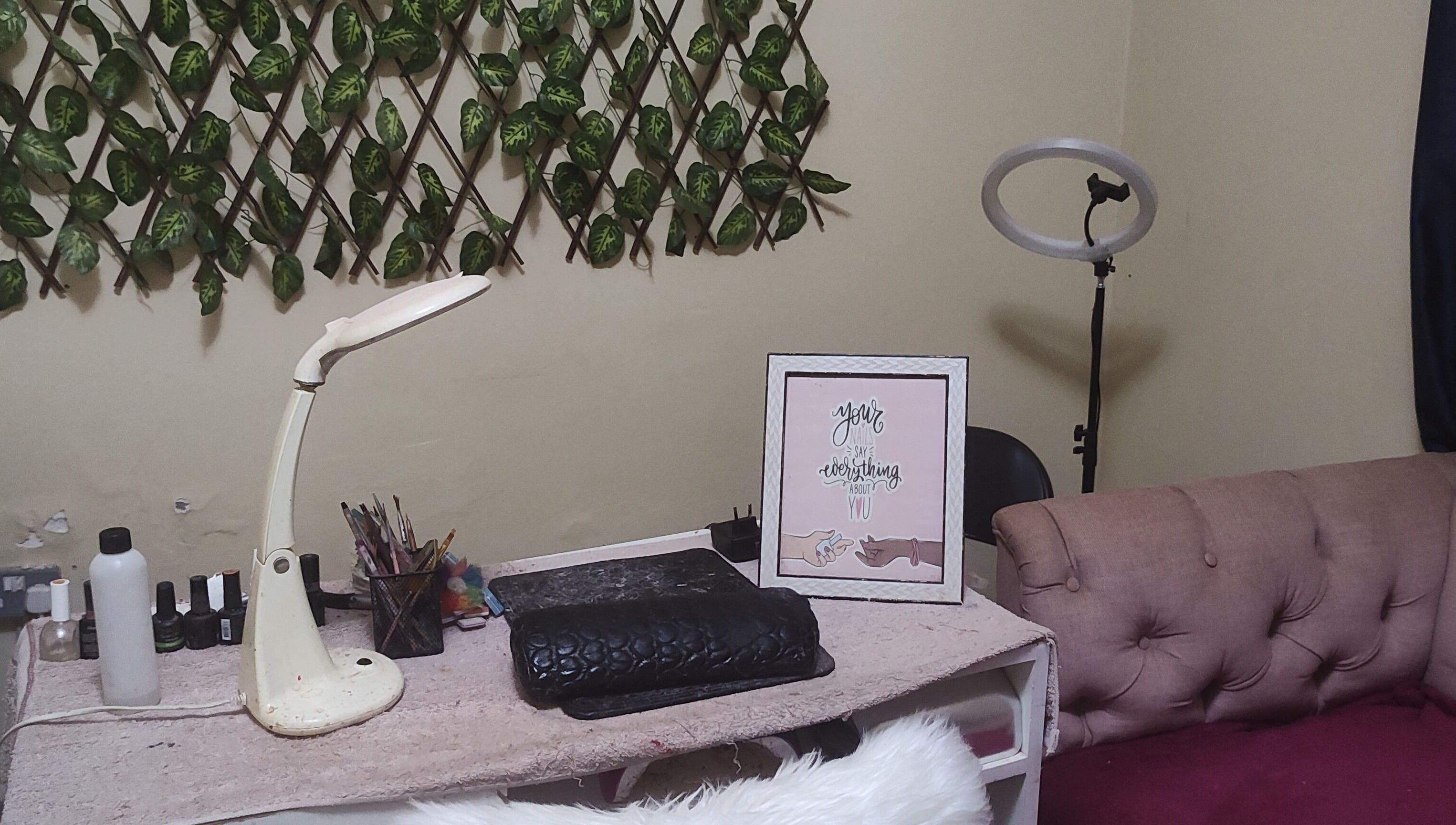 Cozy nail station at Perfect Polish in Lusaka, Lusaka Province, ZM, with decor, lamp, and tools.