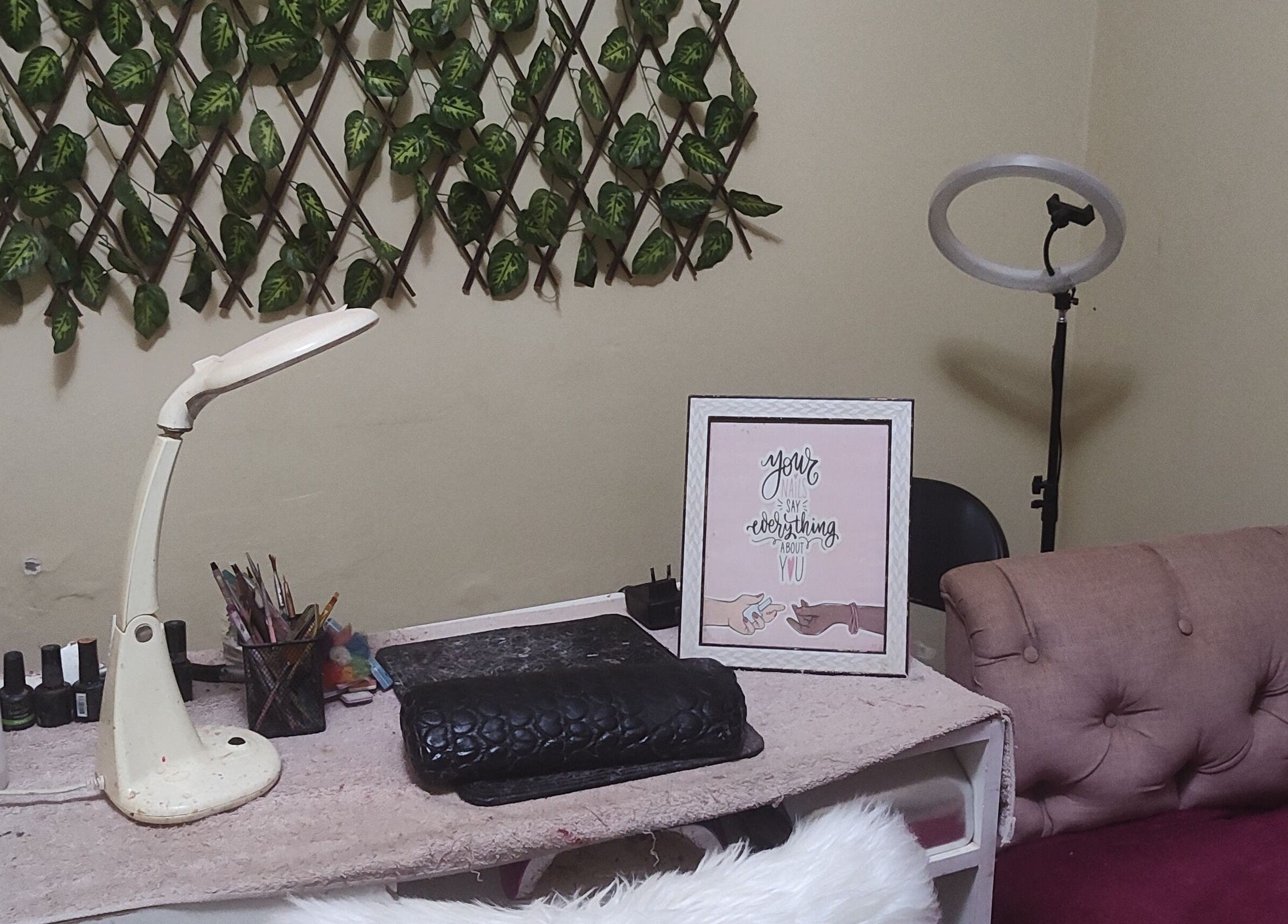 Cozy nail station at Perfect Polish in Lusaka, Lusaka Province, ZM, with decor, lamp, and tools.