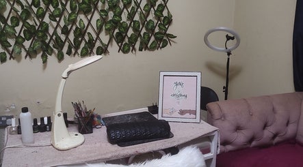 Cozy nail station at Perfect Polish in Lusaka, Lusaka Province, ZM, with decor, lamp, and tools.