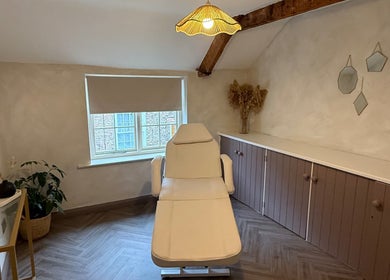 Relaxing treatment room at Bare and Glow Skin, Thirsk, England, GB with a cozy chair and natural decor.