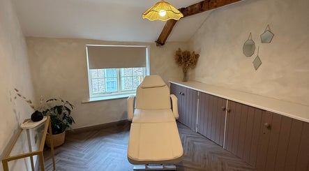 Relaxing treatment room at Bare and Glow Skin, Thirsk, England, GB with a cozy chair and natural decor.