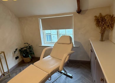 Relaxing treatment room at Bare and Glow Skin, Thirsk, England, GB, featuring a comfortable recliner.