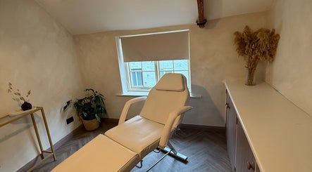 Relaxing treatment room at Bare and Glow Skin, Thirsk, England, GB, featuring a comfortable recliner.