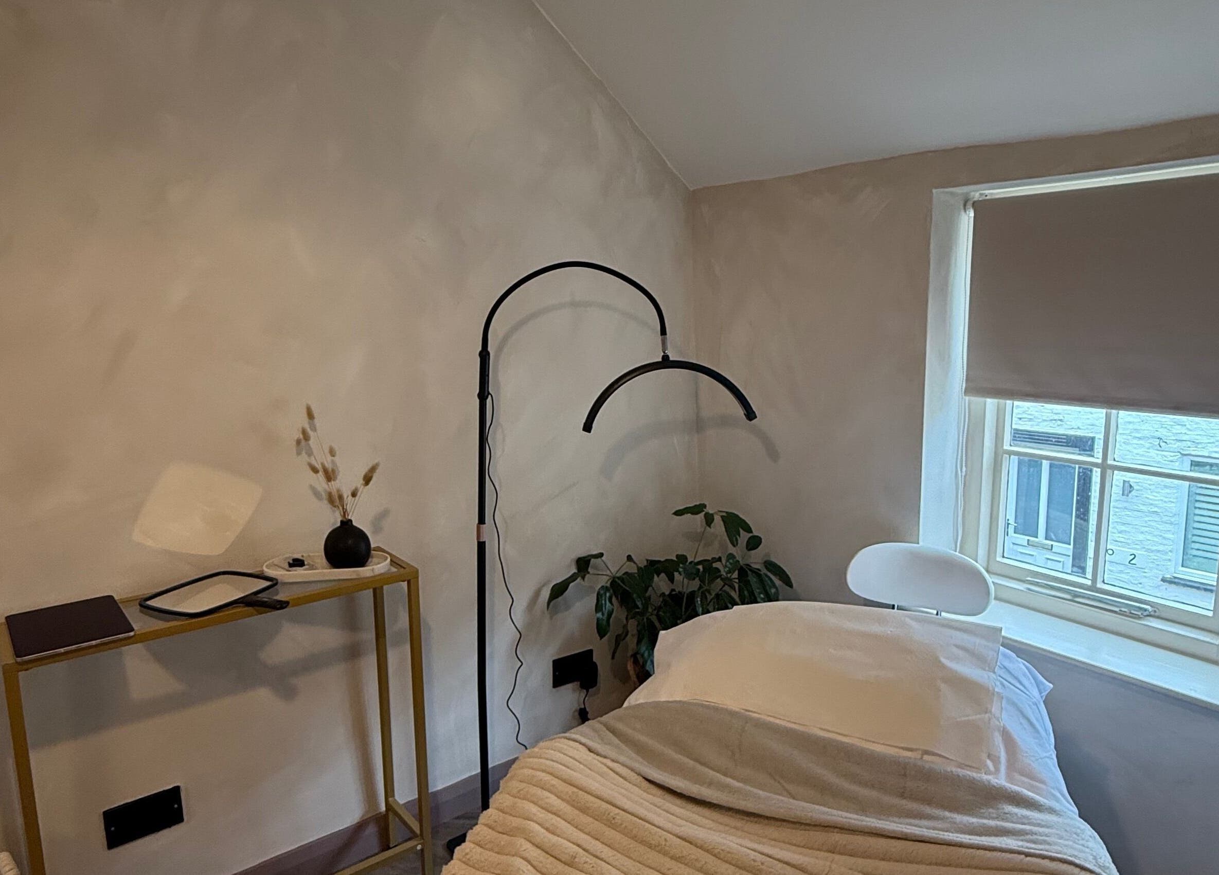 Relaxing treatment room at Bare and Glow Skin, Ripon, England, GB, featuring cozy bed and natural decor.