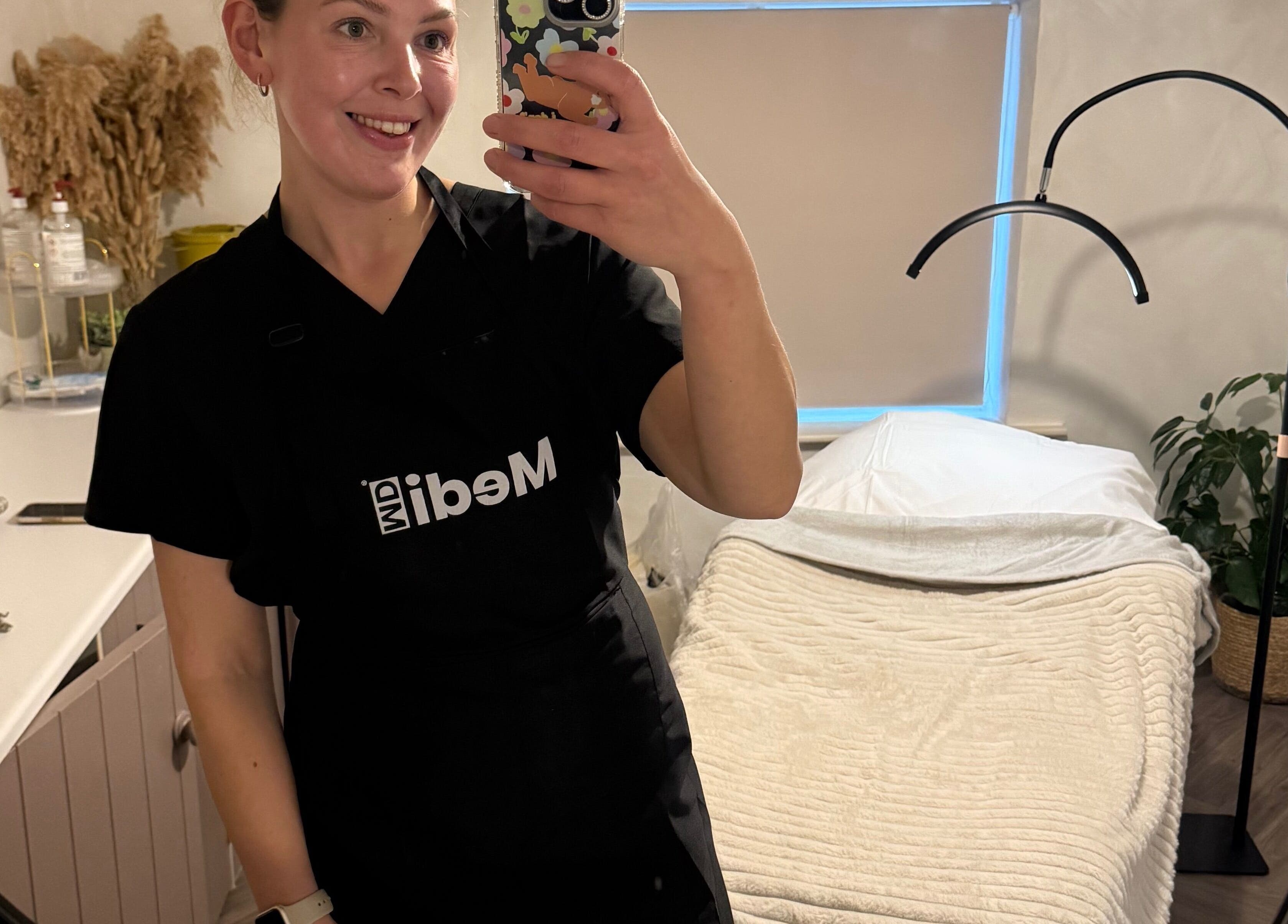 Smiling professional in cozy treatment room at Bare and Glow Skin, Ripon, England, GB.