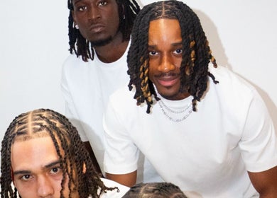 Group of three men with stylish braids at Hairslayedbydee, Manchester, England, GB.