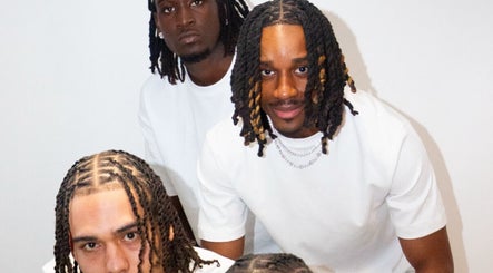 Group of three men with stylish braids at Hairslayedbydee, Manchester, England, GB.