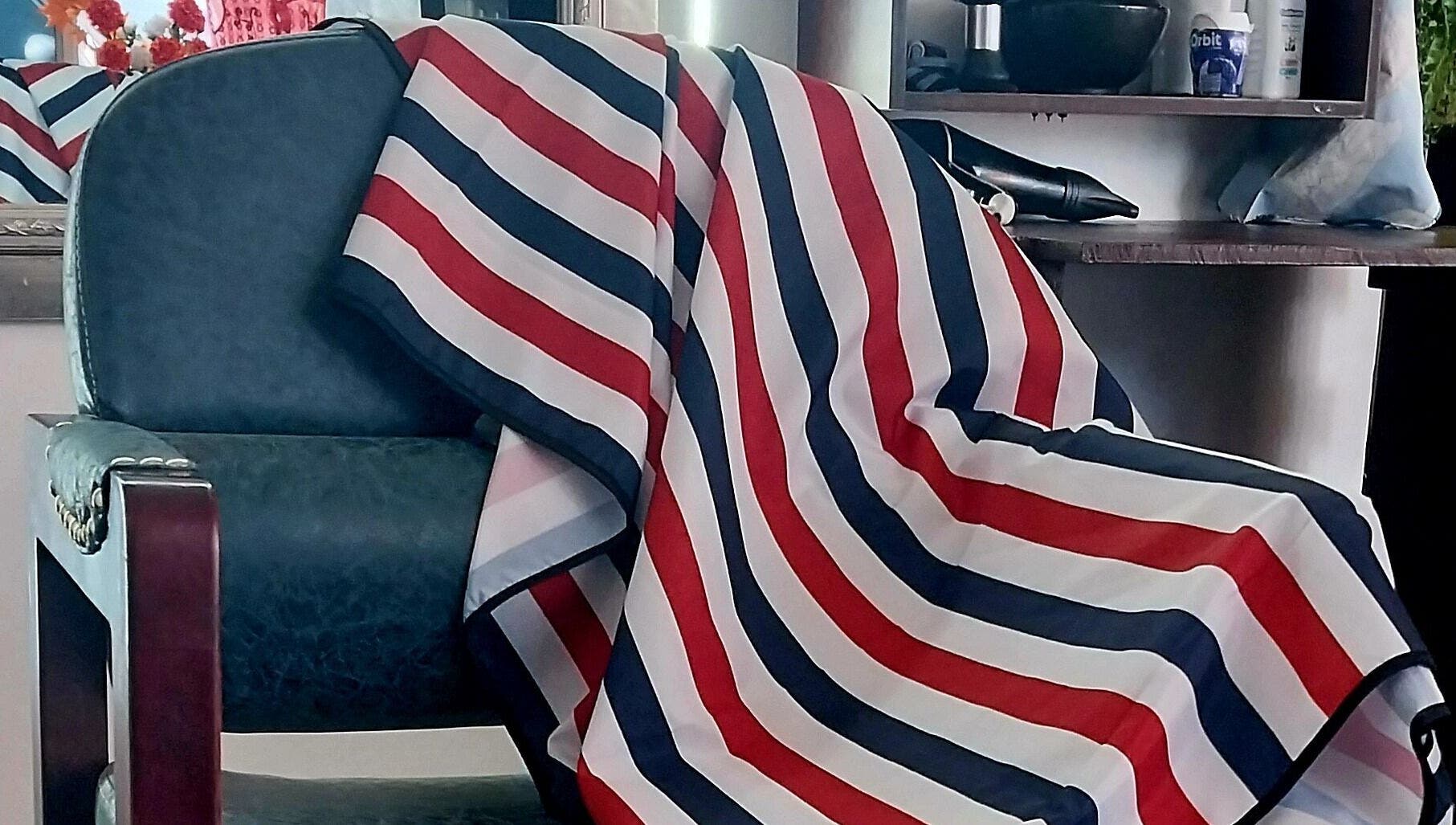 Barber chair draped with striped cloth at Blendculture, Windhoek, Khomas Region, NA, embodying salon elegance.
