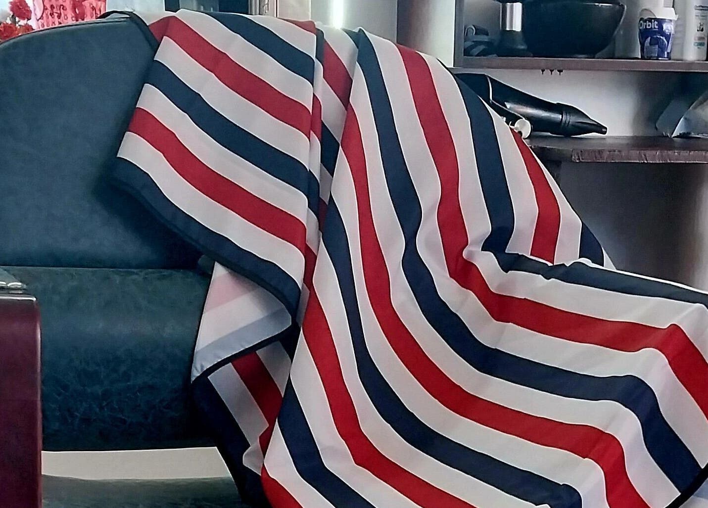 Barber chair draped with striped cloth at Blendculture, Windhoek, Khomas Region, NA, embodying salon elegance.