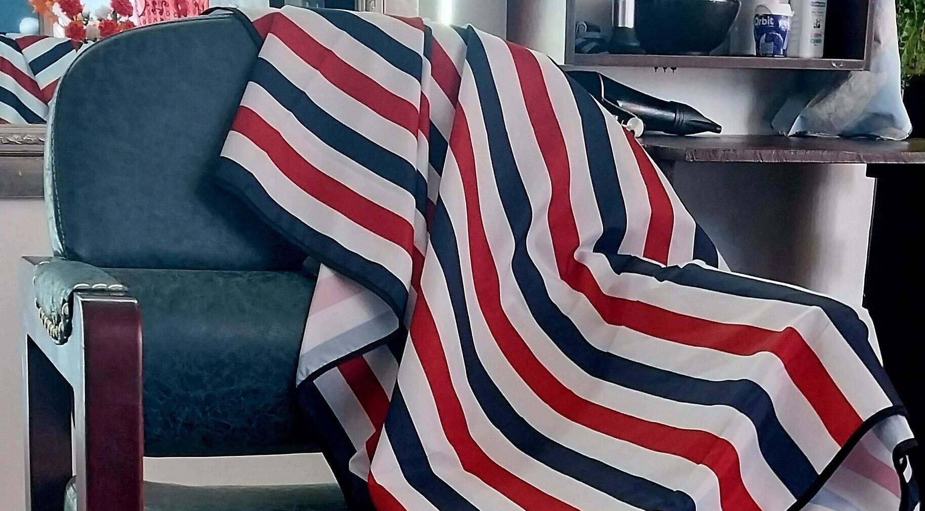 Barber chair draped with striped cloth at Blendculture, Windhoek, Khomas Region, NA, embodying salon elegance.