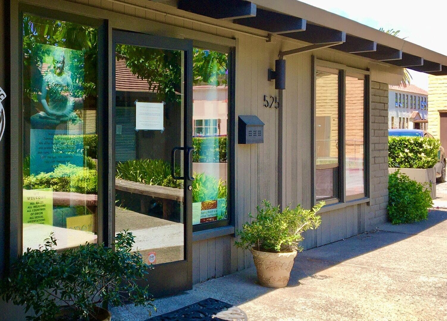 Entrance of Therapeutic Touch, Sonoma, California, US. Welcoming facade with lush greenery.