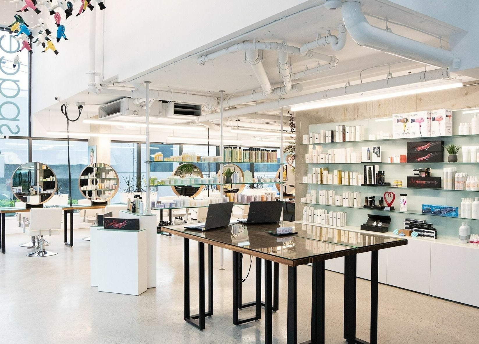 Modern interior of Space Salon - Vancouver in Vancouver, British Columbia, CA with stylish decor and product displays.