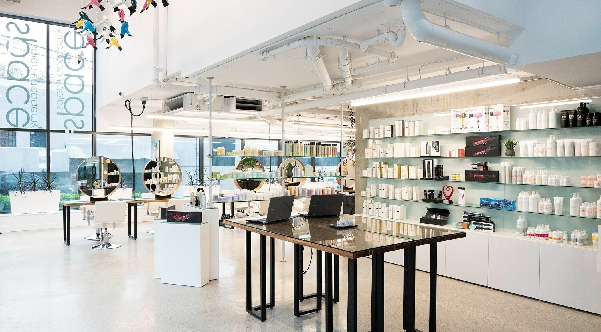 Modern interior of Space Salon - Vancouver in Vancouver, British Columbia, CA with stylish decor and product displays.