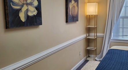 Relaxing massage room at Magnolia Massage Arts, Cary, North Carolina, US with calming decor and soft lighting.