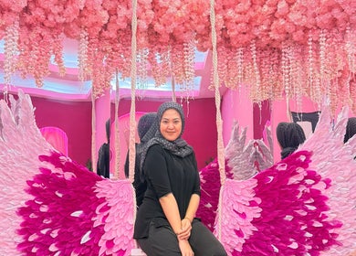 Vibrant pink floral decor at Barbie Lash Empire, Kuala Lumpur, with angel wings display.