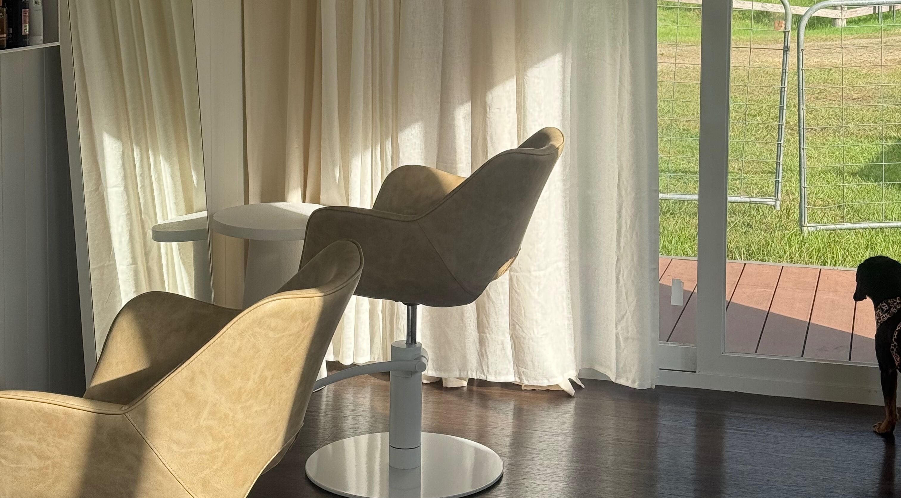 Elegant chairs with sunlight at By Charlotte Anne, Conondale, Queensland, AU offering serene wellness.