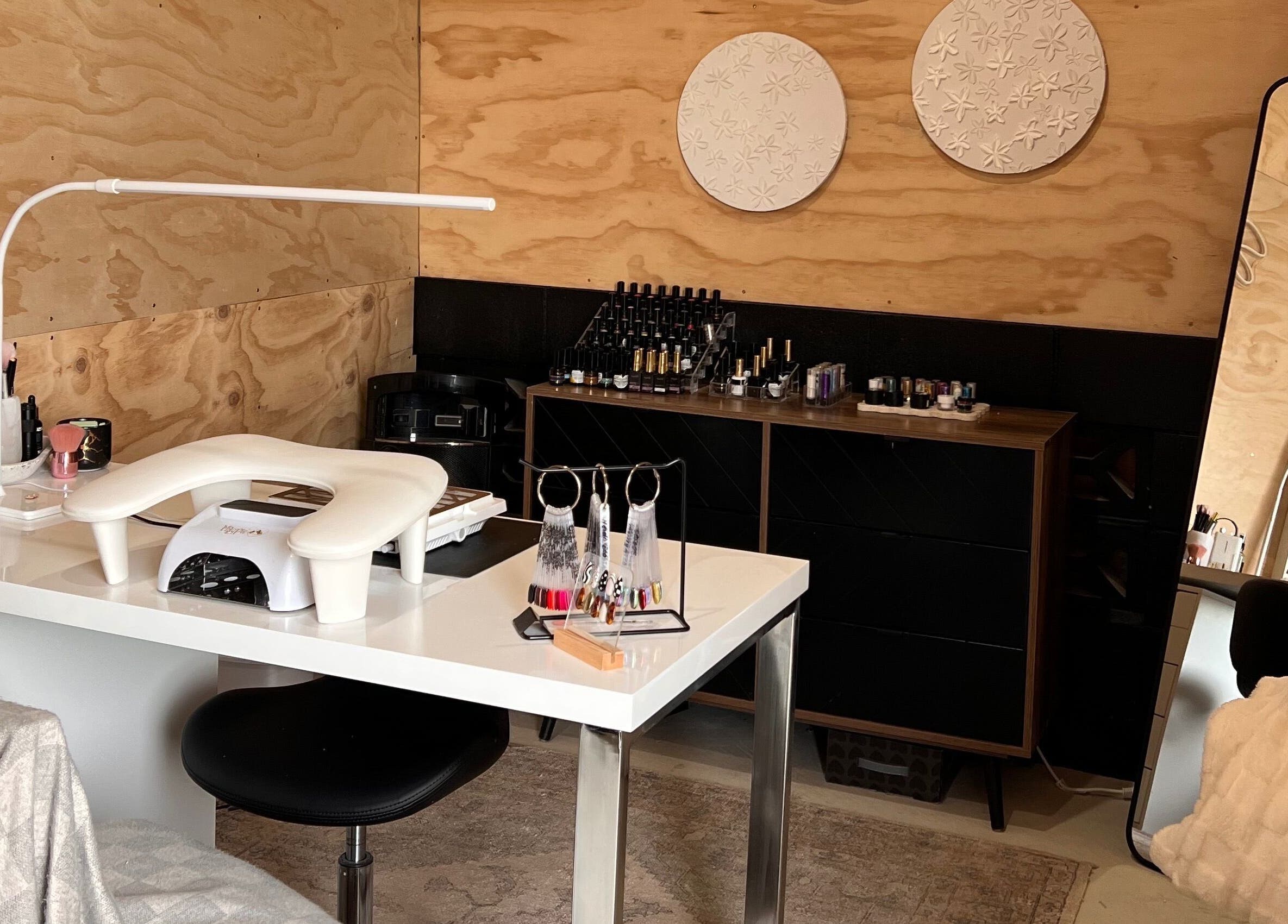 Nail workstation at Studio L Nails, New Plymouth, Taranaki Region, NZ with polish and decor.