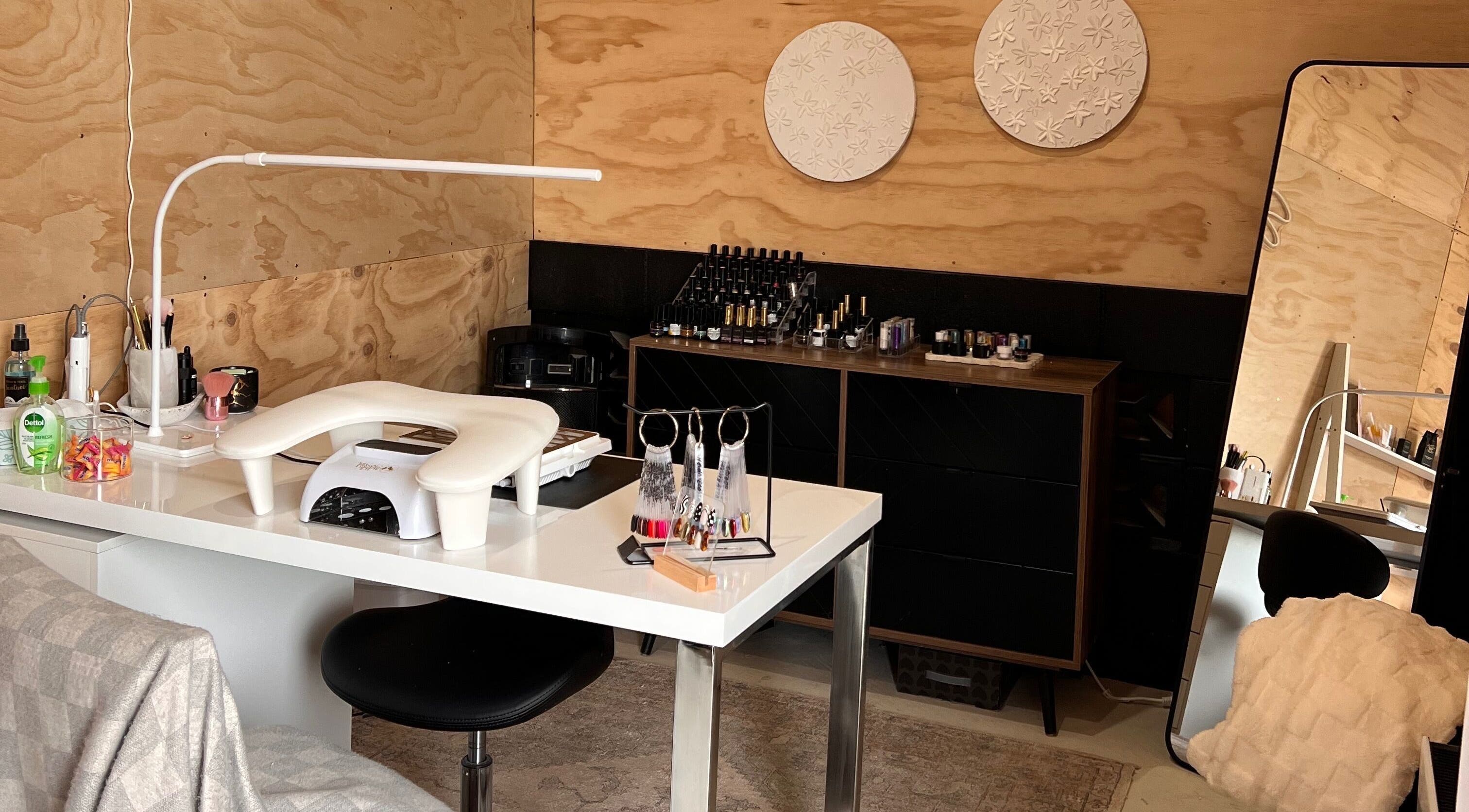 Nail workstation at Studio L Nails, New Plymouth, Taranaki Region, NZ with polish and decor.