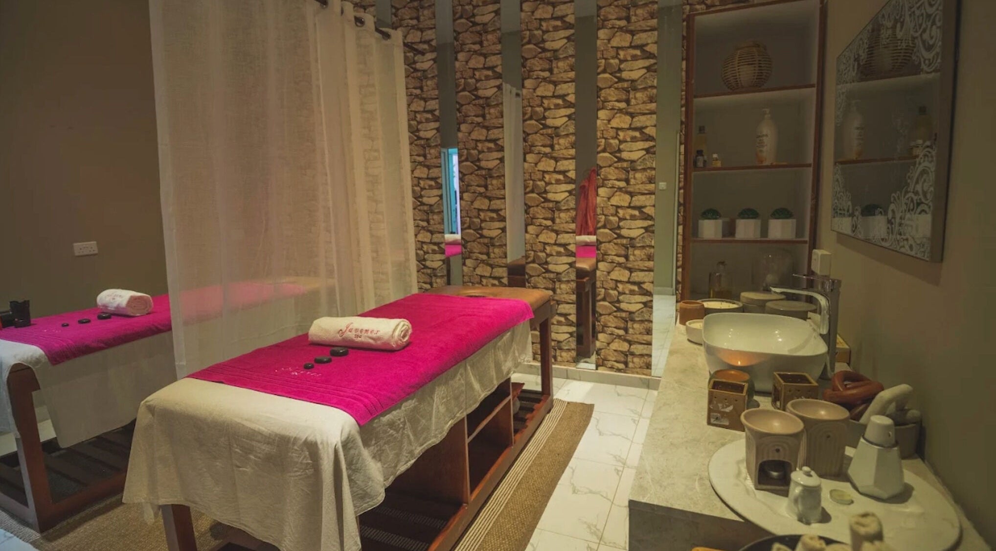 Relaxing massage room at Juvenex Beauty Services - Makeni Branch, Lusaka, Lusaka Province, ZM with warm decor.