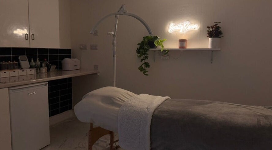 Relaxing treatment room at Simply Beauty, Ramsey, Ramsey, IM, featuring ambient lighting and cozy decor.
