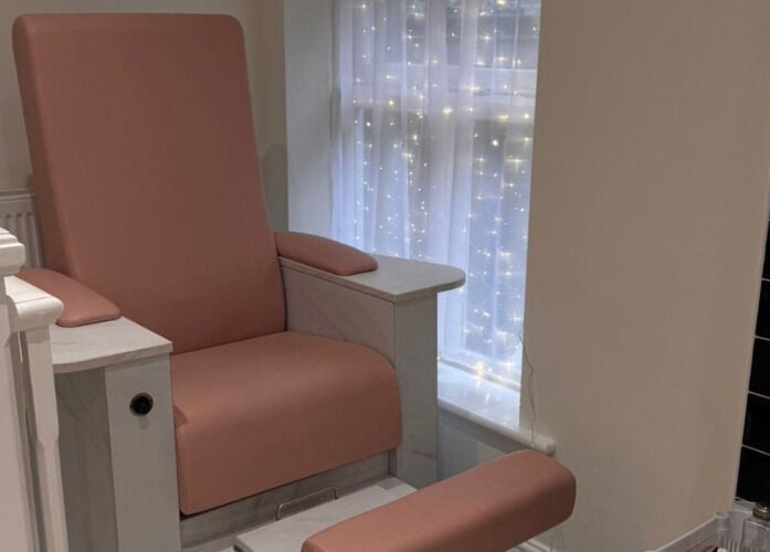 Comfortable pink spa chair at Simply Beauty in Ramsey, Ramsey, IM, perfect for pedicures and relaxation.