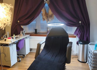 Luxurious treatment room at LM Touch, Horley, England, GB with elegant decor and beauty essentials.