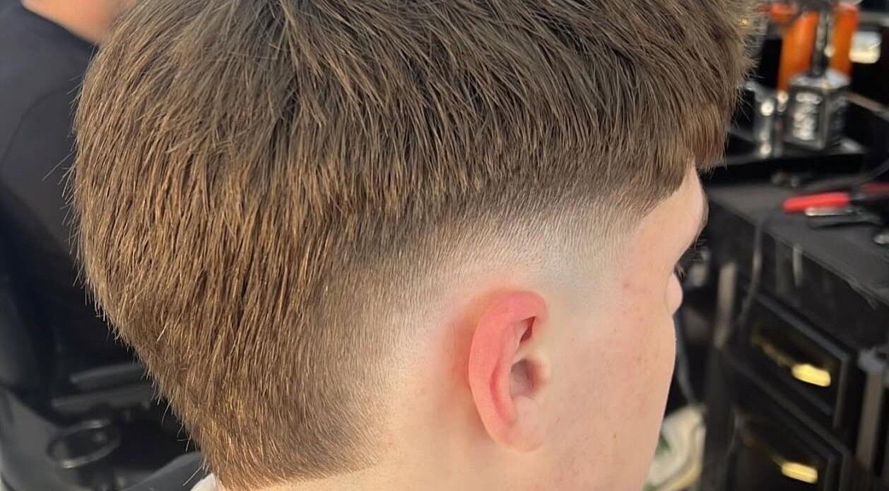 Close-up of a fresh fade haircut at Eden Barbers, Potters Bar, England, GB. Modern hairstyle shown at the ear level.