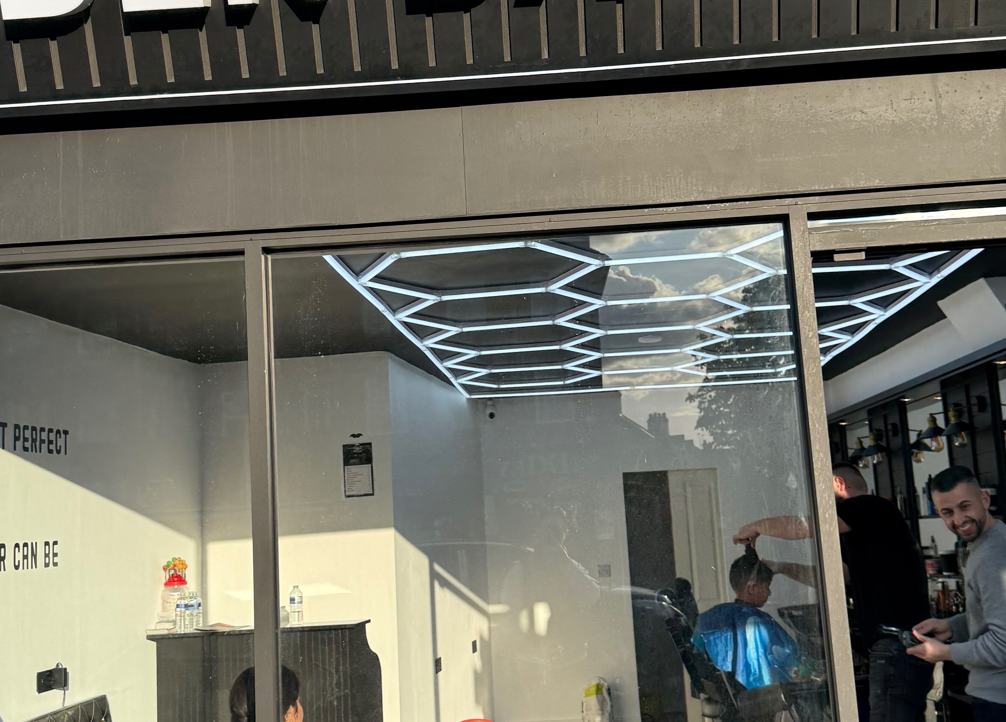 Eden barbers in Potters Bar, England, GB with modern interiors and haircuts in progress.