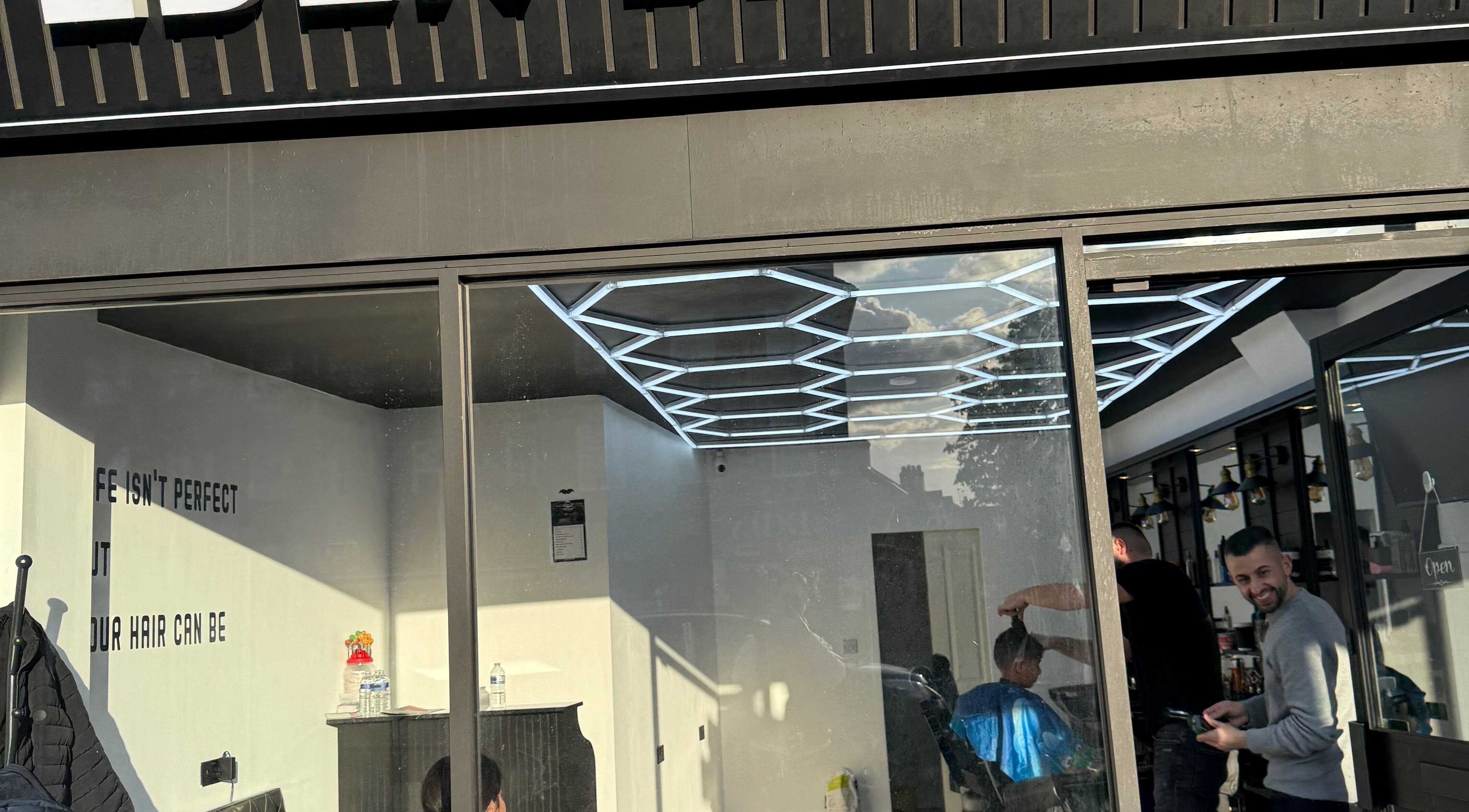 Eden barbers in Potters Bar, England, GB with modern interiors and haircuts in progress.