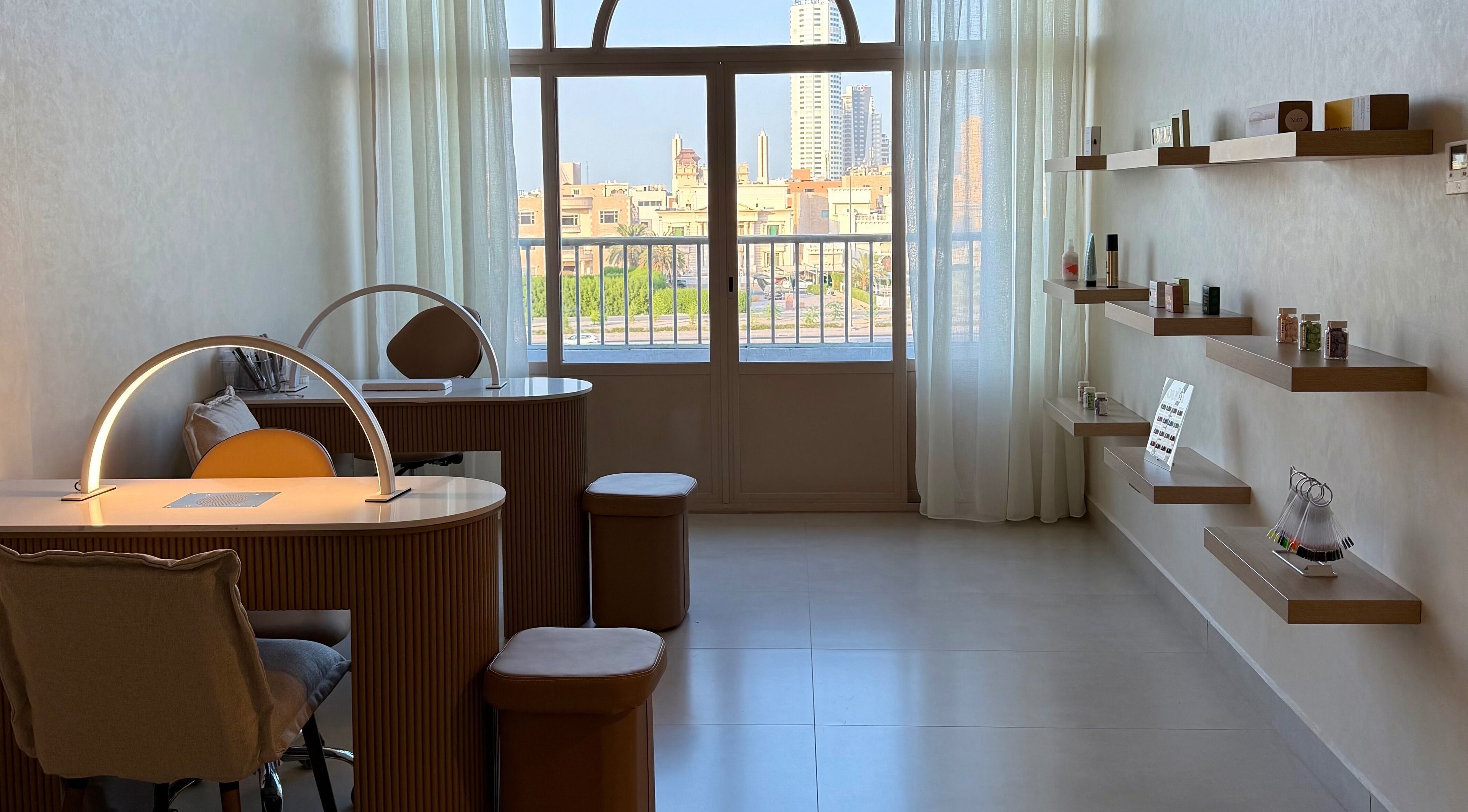 Modern workspace at The Glossary, Hawally, Hawalli Governorate, KW, with bright window view and shelves.