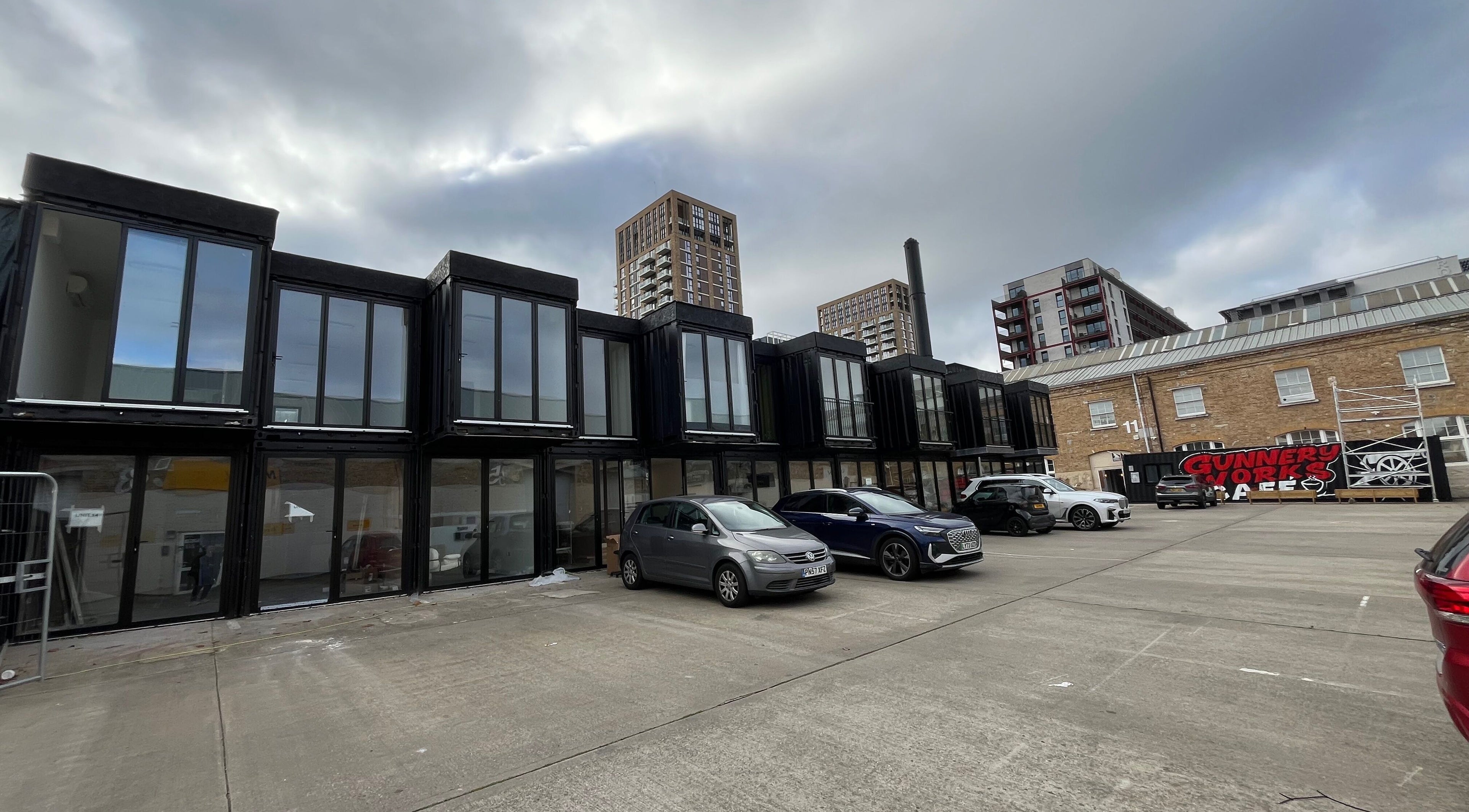 Modern venue exterior of Serenity Massage Therapy in London, England, GB. Contemporary architecture and cars visible.