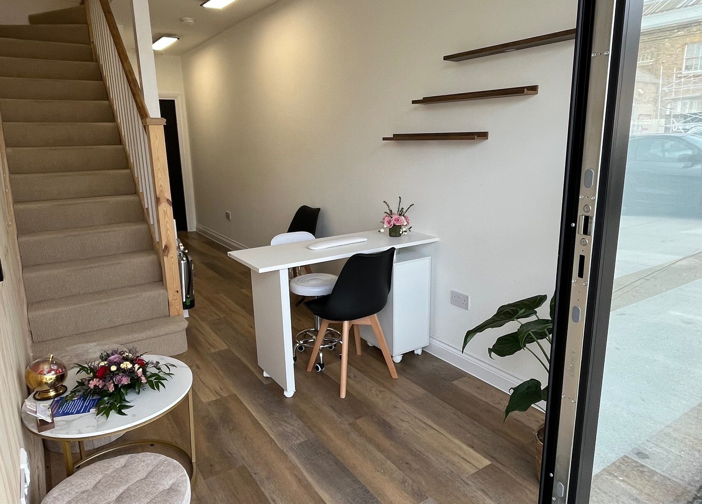 Entrance area at Serenity Massage Therapy, London, England, with minimalist decor and warm lighting.