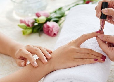 Manicure treatment at Royal Beauty Parlour in Berserker, Queensland, AU with flowers in the background.