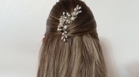 Elegant half-up hairstyle with pearl accessory at Royal Beauty Parlour, Berserker, Queensland, AU.