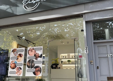 Dalya Cosmo clinic storefront in London, England, GB with glass entrance and beauty posters displayed.