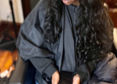 Client relaxing in a salon chair at Elegance Beauty Bar LLC, Philadelphia, Pennsylvania, US.