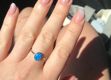 Elegant opal ring on freshly manicured nails at Nails By Valente in Tranent, Scotland, GB.