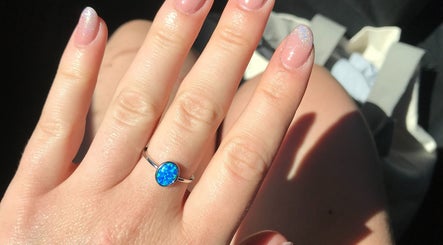 Elegant opal ring on freshly manicured nails at Nails By Valente in Tranent, Scotland, GB.
