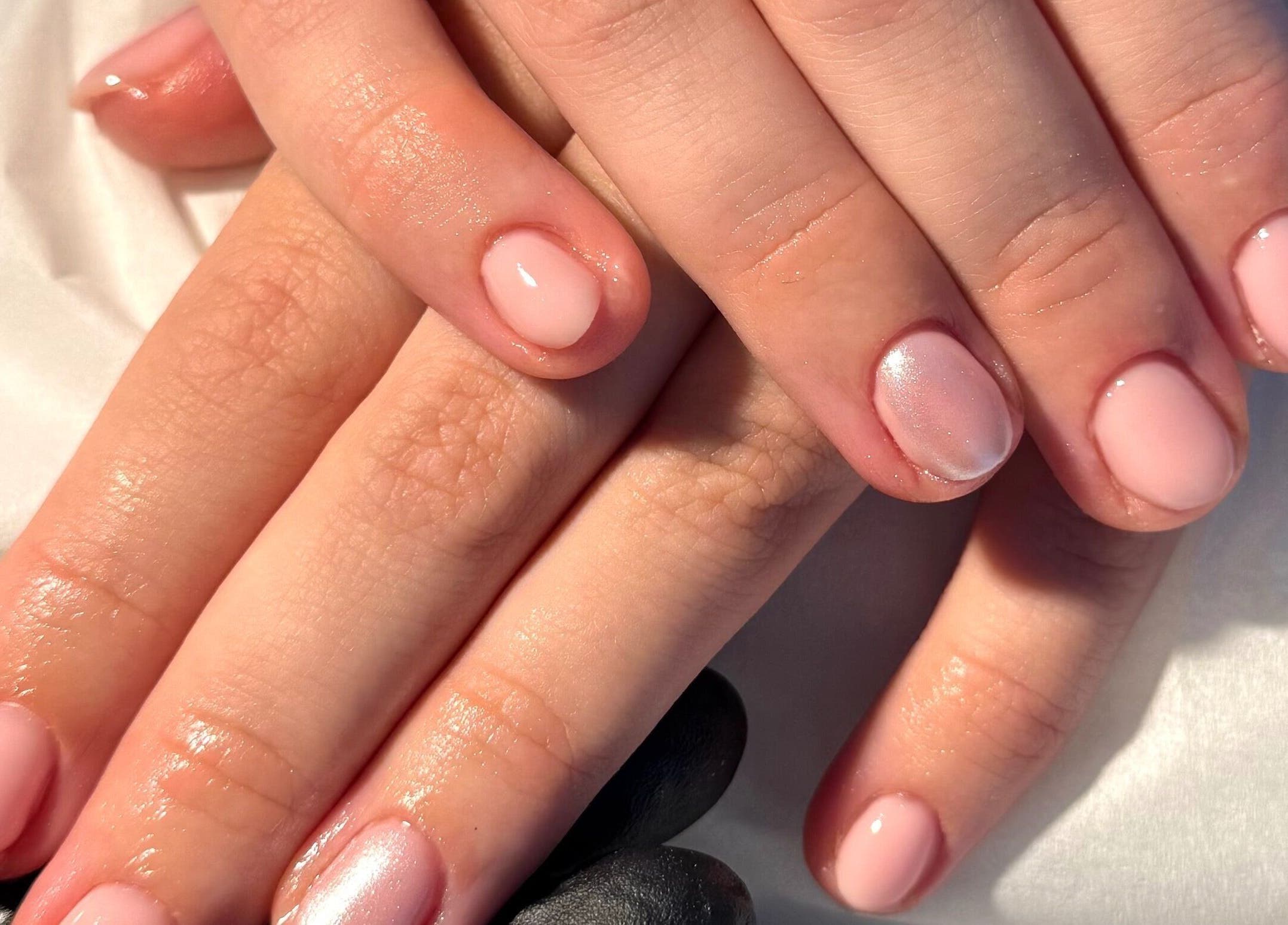 Freshly manicured nails at Nails By Valente in Tranent, Scotland, GB, showcasing glossy pink polish.