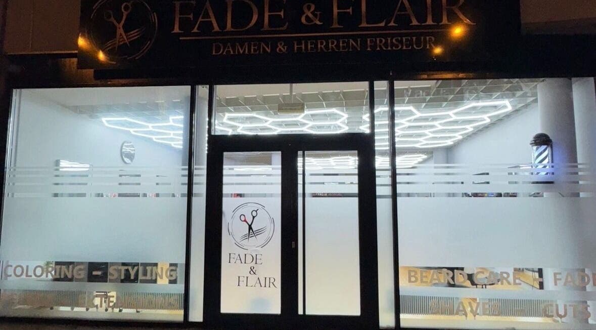 Außenansicht von Fade and Flair in Graz, Steiermark, AT bei Nacht mit leuchtendem Schaufenster.
