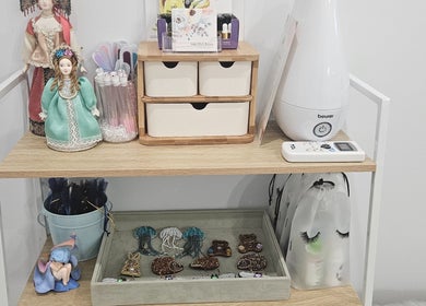 Inner Doll Beauty shelf with decor and equipment in Melbourne, Victoria, AU, showcasing beauty tools and trinkets.