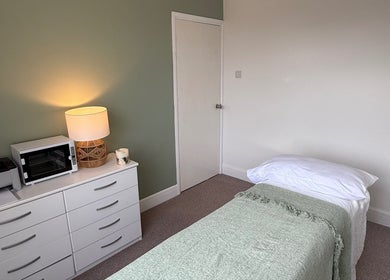 Tranquil therapy room at Jessica's at Chichester, featuring soft lighting and cozy bedding, Chichester, England, GB.