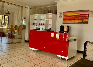 Reception area at SoulSpring Sports & Wellness Spa, Pretoria, Gauteng, ZA, showcasing a stylish red desk.
