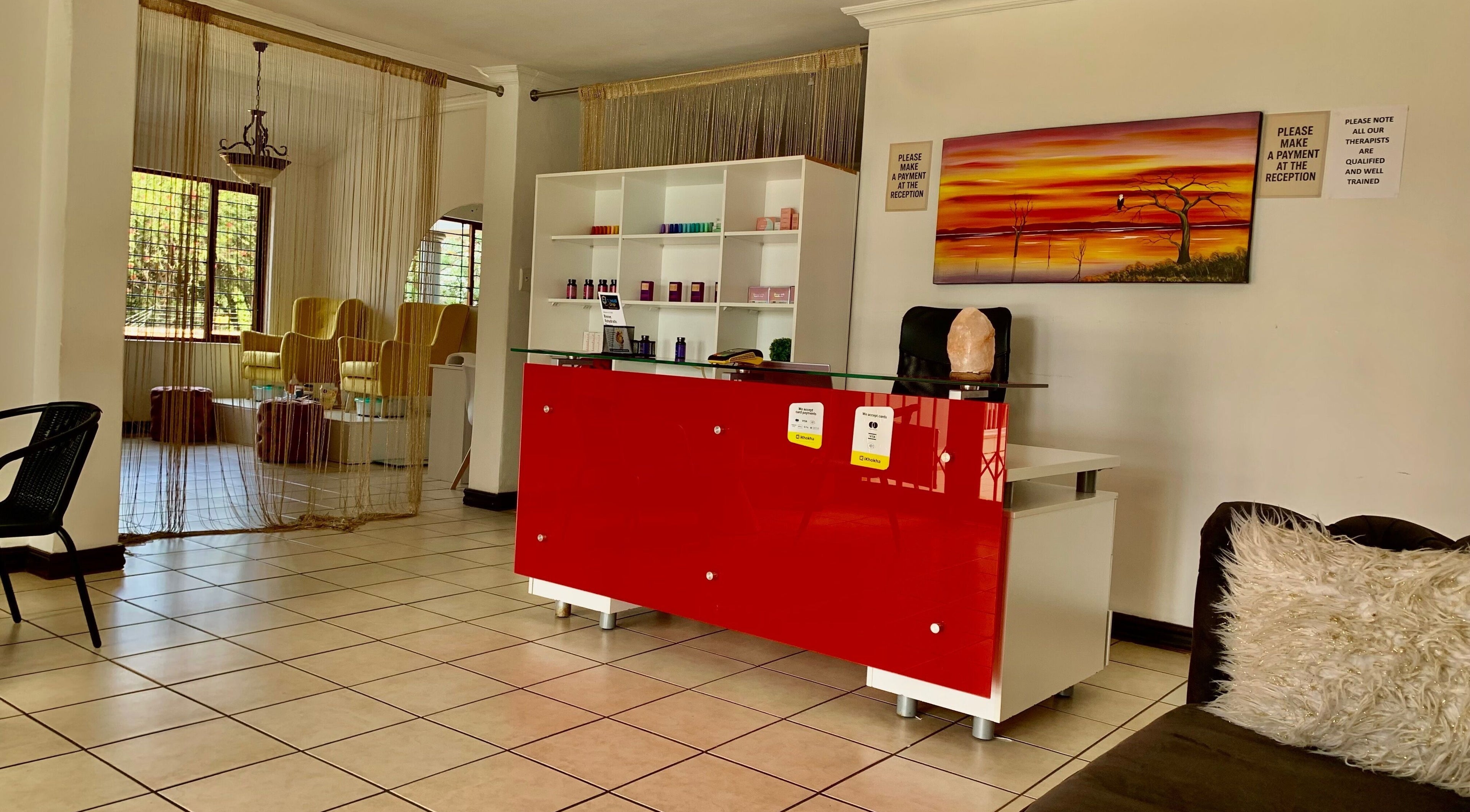 Reception area at SoulSpring Sports & Wellness Spa, Pretoria, Gauteng, ZA, showcasing a stylish red desk.