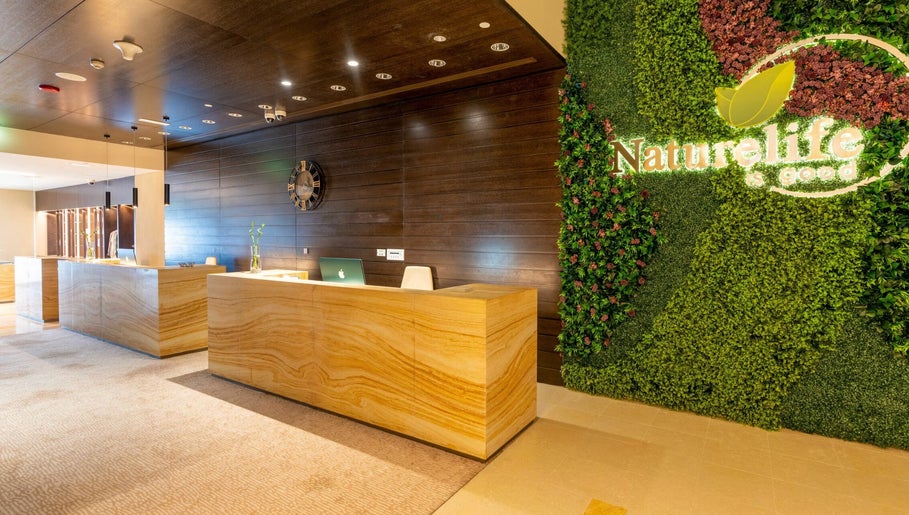 Reception area of Naturelife Spa Marina Abu Dhabi featuring lush green wall, Abu Dhabi, AE.
