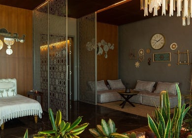 Elegant lounge area at Naturelife Spa Premium, Dubai, AE. Cozy seating, lush plants, warm lighting.