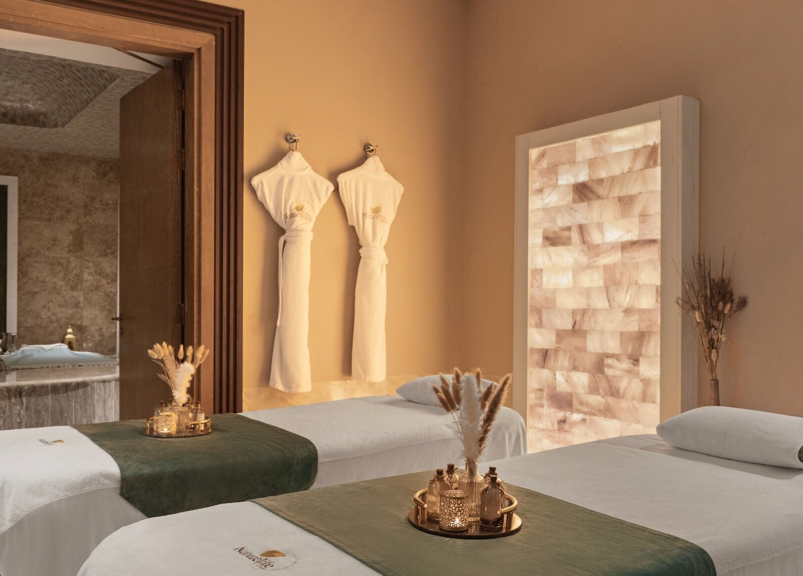 Relaxation room at Naturelife Spa Marina Abu Dhabi with massage tables, robes, and soothing decor. Abu Dhabi, AE.