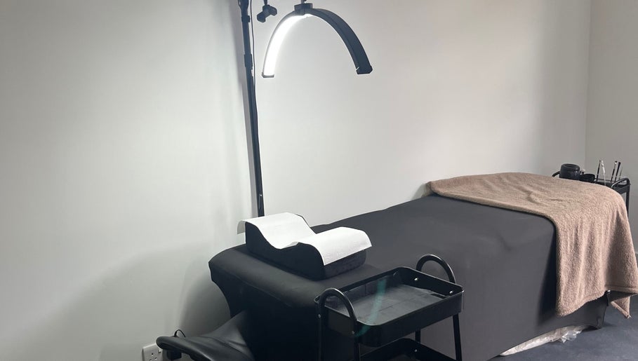 Cozy treatment room at The Beauty Collective in Cork, County Cork, IE with a bed and elegant lighting.