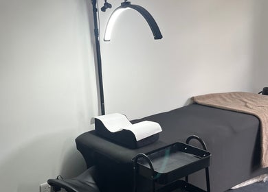 Cozy treatment room at The Beauty Collective in Cork, County Cork, IE with a bed and elegant lighting.