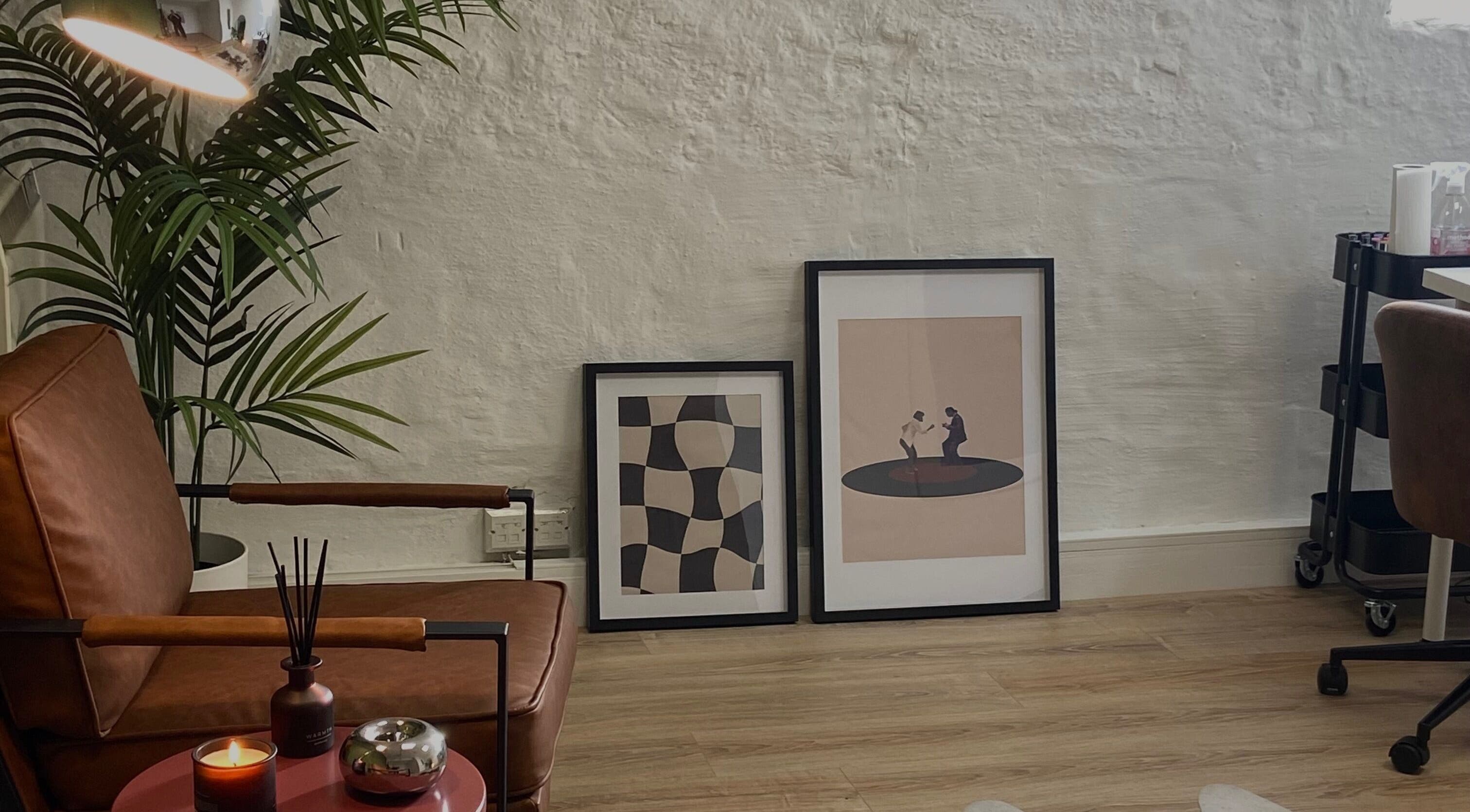 A cozy seating area at June Studios, Edinburgh, Scotland, GB, featuring modern art and comfortable decor.